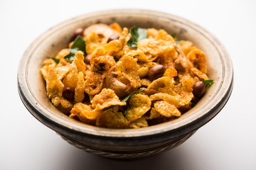 Cornflake Chivda or Corn Chiwda loaded with peanuts and Cashew. Served in a bowl. selective focus
