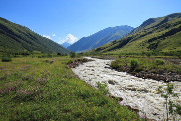 Landscape views of the Caucasus Mountains, river and villages. Peak and river Enguri. Georgia. Summer. 2019