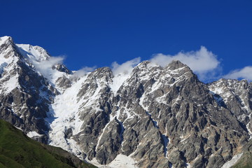 Landscape views of the Caucasus Mountains, river and villages. Peak and river Enguri. Georgia. Summer. 2019