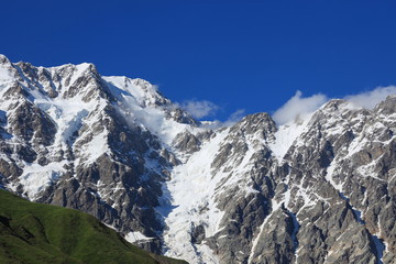 Landscape views of the Caucasus Mountains, river and villages. Peak and river Enguri. Georgia. Summer. 2019