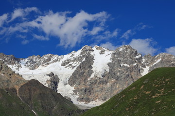 Landscape views of the Caucasus Mountains, river and villages. Peak and river Enguri. Georgia. Summer. 2019