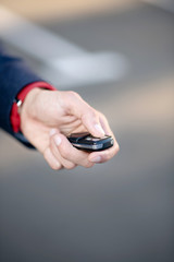 Close up of man wearing red watch holding car keys