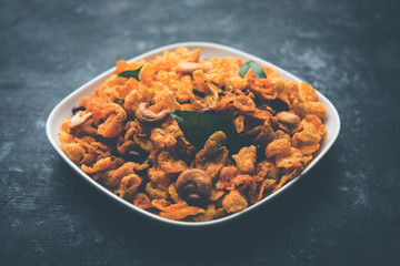 Cornflake Chivda or Corn Chiwda loaded with peanuts and Cashew. Served in a bowl. selective focus