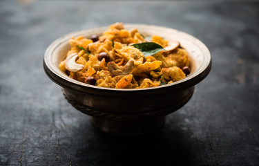 Cornflake Chivda or Corn Chiwda loaded with peanuts and Cashew. Served in a bowl. selective focus