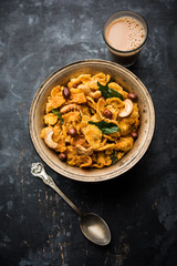 Cornflake Chivda or Corn Chiwda loaded with peanuts and Cashew. Served in a bowl. selective focus