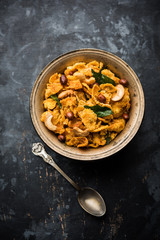 Fototapeta premium Cornflake Chivda or Corn Chiwda loaded with peanuts and Cashew. Served in a bowl. selective focus