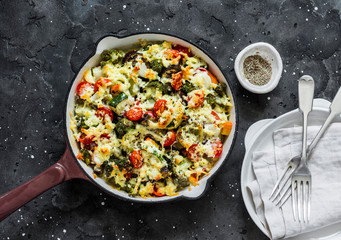 Vegetarian casserole ratatouille, baked in a frying pan on a dark background, top view