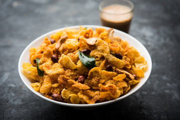 Cornflake Chivda or Corn Chiwda loaded with peanuts and Cashew. Served in a bowl. selective focus