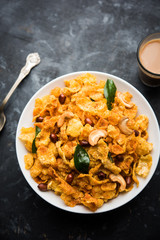 Cornflake Chivda or Corn Chiwda loaded with peanuts and Cashew. Served in a bowl. selective focus