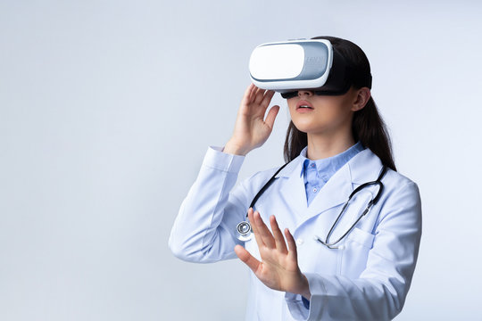 Lady Doctor Wearing Virtual Reality Headset, White Background - Powered by Adobe