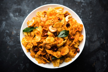 Cornflake Chivda or Corn Chiwda loaded with peanuts and Cashew. Served in a bowl. selective focus