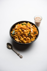 Cornflake Chivda or Corn Chiwda loaded with peanuts and Cashew. Served in a bowl. selective focus