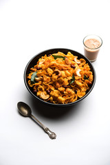 Cornflake Chivda or Corn Chiwda loaded with peanuts and Cashew. Served in a bowl. selective focus