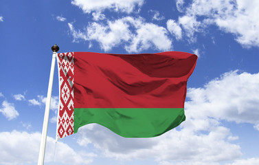 Flag of Belarus, wide red horizontal banner at the top and narrow green banner at the bottom, the vertical banner with red designs depicting Belarusian culture.