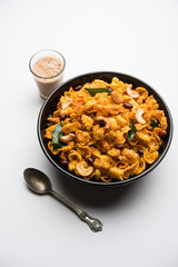 Cornflake Chivda or Corn Chiwda loaded with peanuts and Cashew. Served in a bowl. selective focus