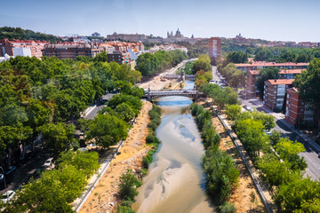 Fototapeta premium Madrid, Spain - August 25, 2019: Aerial view of the Manzanares River as it passes through Madrid.