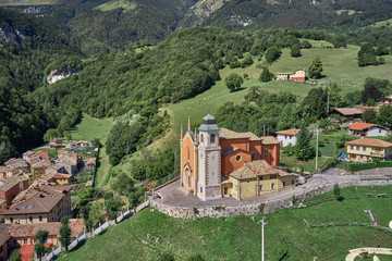 Fototapeta na wymiar Panorama view of Parrocchia S. Caterina V.M. Ferrara di Monte Baldo is a city in the province of Verona. Flight by a drone. Popular travel destination in Nothern Italy.