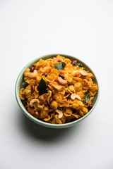 Cornflake Chivda or Corn Chiwda loaded with peanuts and Cashew. Served in a bowl. selective focus