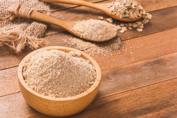 close-up of brown bread flour grain in bowl on wooden table