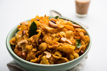 Cornflake Chivda or Corn Chiwda loaded with peanuts and Cashew. Served in a bowl. selective focus