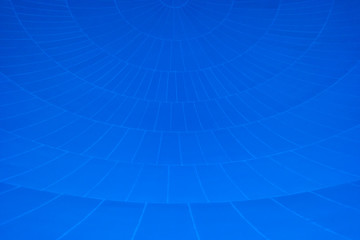 Pattern of converging lines on a dome with blue background.