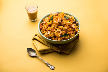 Cornflake Chivda or Corn Chiwda loaded with peanuts and Cashew. Served in a bowl. selective focus
