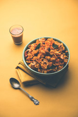 Cornflake Chivda or Corn Chiwda loaded with peanuts and Cashew. Served in a bowl. selective focus