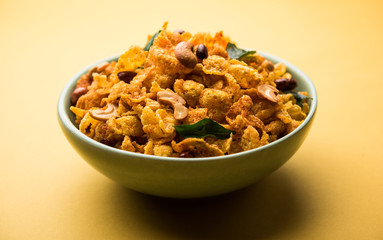 Cornflake Chivda or Corn Chiwda loaded with peanuts and Cashew. Served in a bowl. selective focus