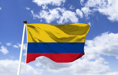 Fototapeta na wymiar Colombia flag mockup, fluttering under blue sky. Country in the far north of South America, marked by the Andes. Capital of Bogota. Cartagena, on the Caribbean coast, has a walled colonial city.