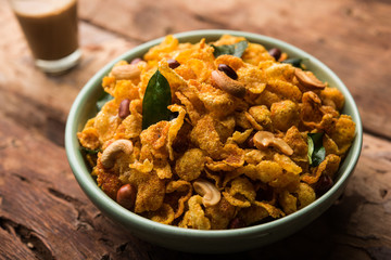 Cornflake Chivda or Corn Chiwda loaded with peanuts and Cashew. Served in a bowl. selective focus