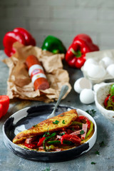 Omelet with pepper and salami.style rustic