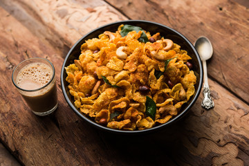 Cornflake Chivda or Corn Chiwda loaded with peanuts and Cashew. Served in a bowl. selective focus
