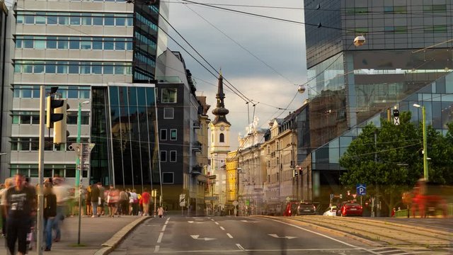 Timelapse zoom in view of a small baroque church surrounded by modern buildings in Vienna, Austria