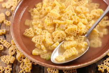 broth with christmas pasta in bowl