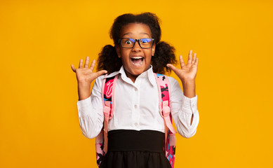 African American Elementary School Girl Shouting In Surprise, Studio Shot
