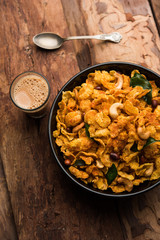 Cornflake Chivda or Corn Chiwda loaded with peanuts and Cashew. Served in a bowl. selective focus