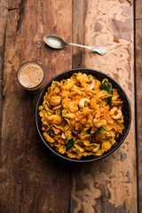 Cornflake Chivda or Corn Chiwda loaded with peanuts and Cashew. Served in a bowl. selective focus