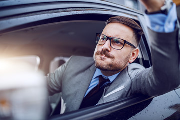 A sharp dressed man finding himself caught in a rush hour and slowly succumbing to road rage.