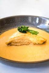 Delicious freshly cooked creamy crab lasagna served on a white table in seafood restaurant. 