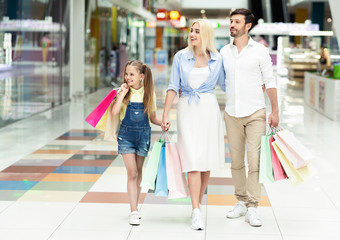 Family Spending Time Together Walking After Shopping In Mall