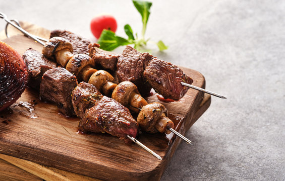 Beef Shish kebab and mushrooms, cherry tomato and ketchup Grilled meat skewers. BBQ lanch. Copyspace