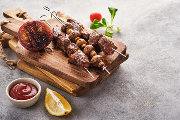 Beef Shish kebab and mushrooms, cherry tomato and ketchup Grilled meat skewers. BBQ lanch