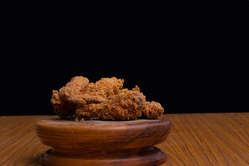Delicious crispy fried chicken on black background