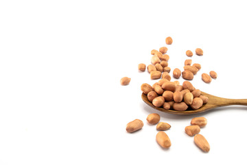 Peanuts in a wooden spoon And some are scattered  isolated on a white background