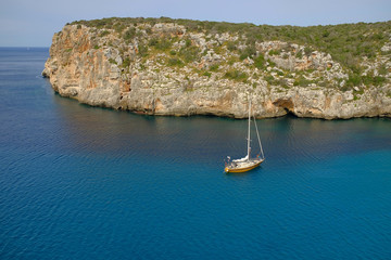 View on white boat on the beach Cala en Porter, Menorca.