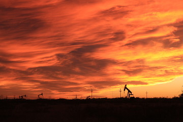 Fototapeta na wymiar Wild sunset and oilfield pumpjacks.
