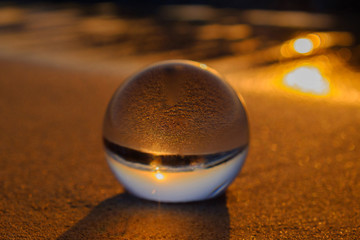 Crystal ball on the sandy beach.