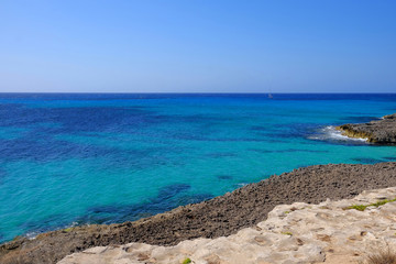 View on the beach Son Bou and white boat on the Balearic Island Menorca, Spain.