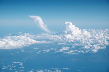 Blue sky background with fluffy clouds.