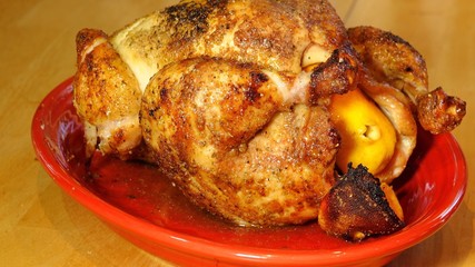 A whole rotisserie roasted chicken on platter
